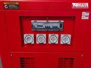 Close-up of the generator outlet panel with four covered power outlets and breaker switches set into the red side cabinet.