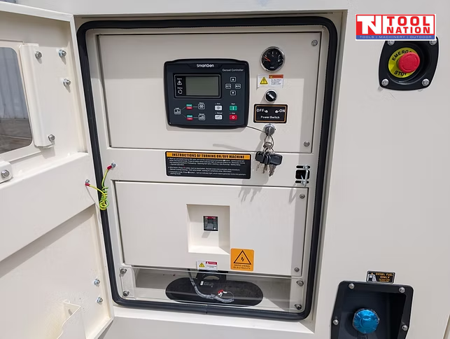 Close-up of the generator control panel with digital controller, gauges, key switch, and covered outlet socket.
