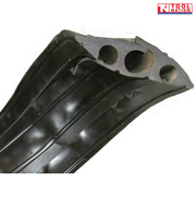 Close-up underside view of a black three-channel cable protector showing three round cable openings and raised underside ribs.