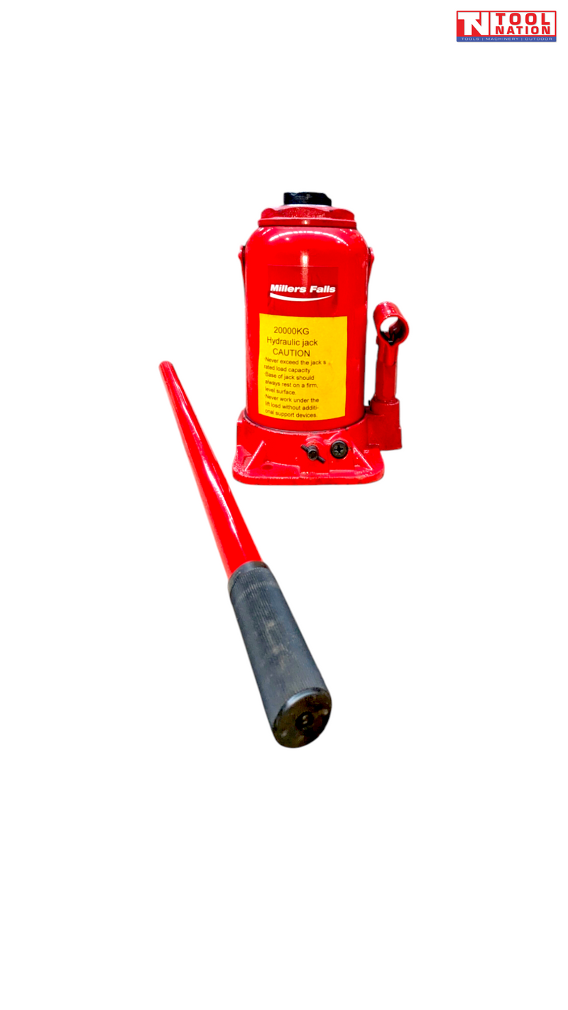 Front view of a red hydraulic bottle jack with warning label and detached handle placed diagonally in the foreground.