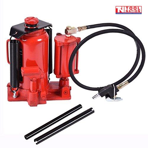 Close-up of red air hydraulic bottle jack with hose, air connector, and two black handle bars