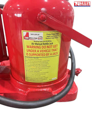 Close-up of red air hydraulic truck jack showing warning label, black hose, and carry handle