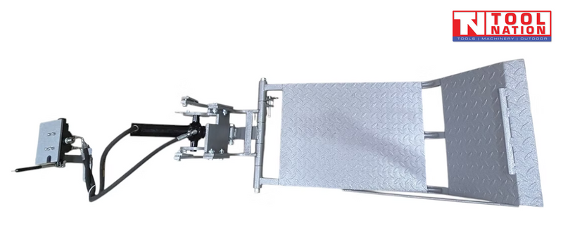 Silver lift table kit with textured platform, hinge brackets, hydraulic hose, and a logo in the top right corner.