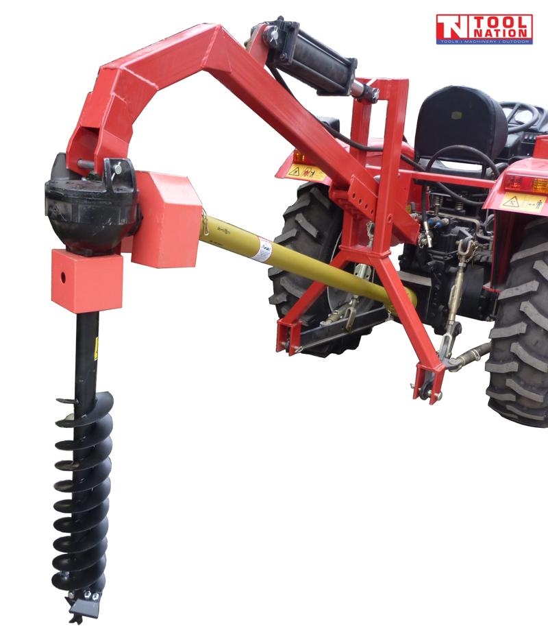 Red tractor-mounted post hole digger with black auger, yellow PTO shaft, hydraulic cylinder, tractor rear section, and logo in the top corner.