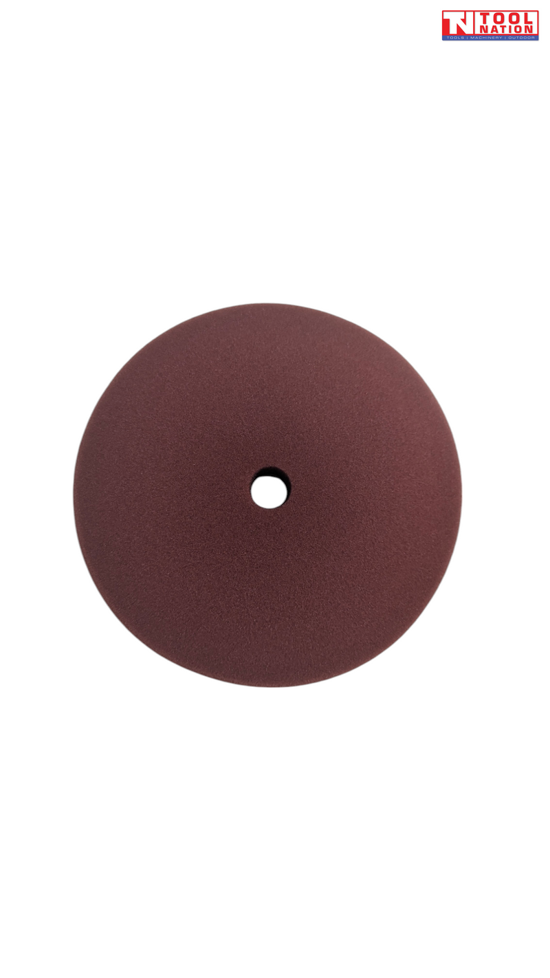 Dark red round polishing pad with centre hole and logo in the top corner.