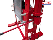 Upper front close-up of the red shop press showing the 100 ton label, pressing head, and pressure gauge.