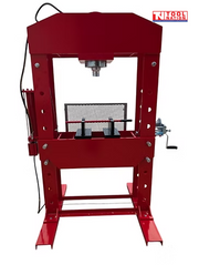 Close-up of a yellow foot pedal attached to the red base frame of the shop press.