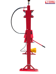 Side profile of the red shop press frame with black hose, pressure gauge, press bed, handle, and yellow foot pedal partly visible.
