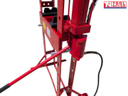 Close-up of the red side hydraulic cylinder and red handle mounted on the frame of the shop press.
