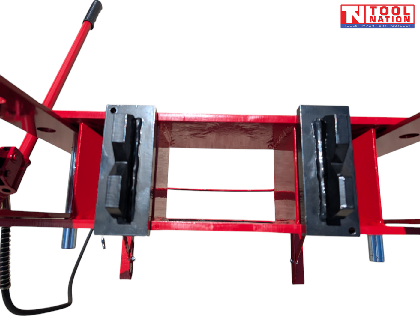 Top-down view of the red press bed with two black press plates and part of the red handle visible.