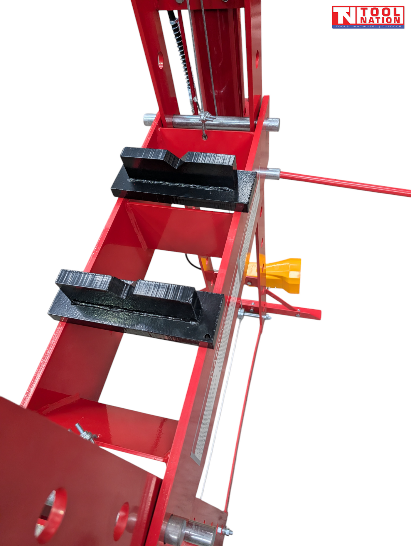 Close-up of black press plates on red support bed