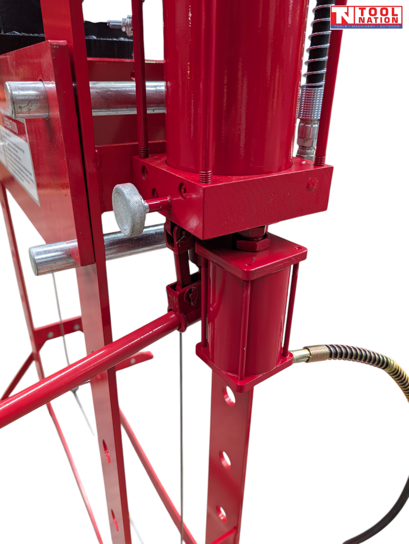 Close-up of red side hydraulic cylinder, handle, adjustment knob, and hose connection