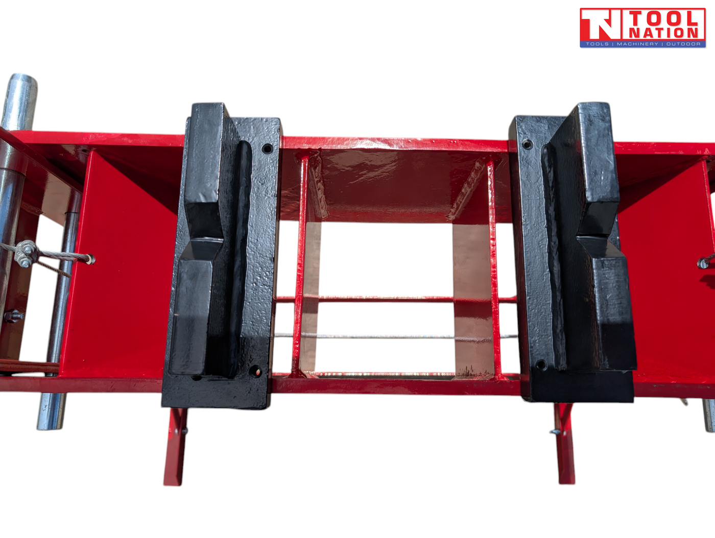 Close-up of black press plates on red support bed