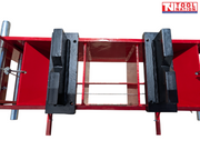 Close-up of black press plates on red support bed