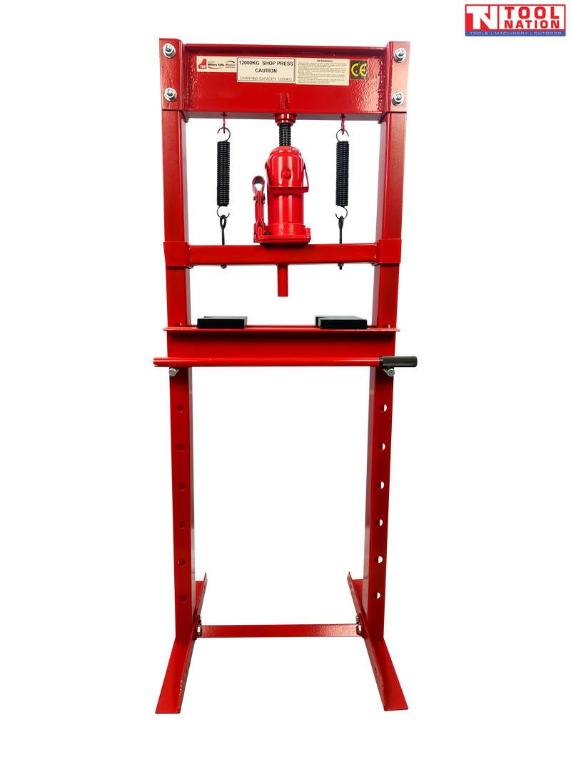 Front view of red shop press with bottle jack, return springs, press plates, and handle on black background