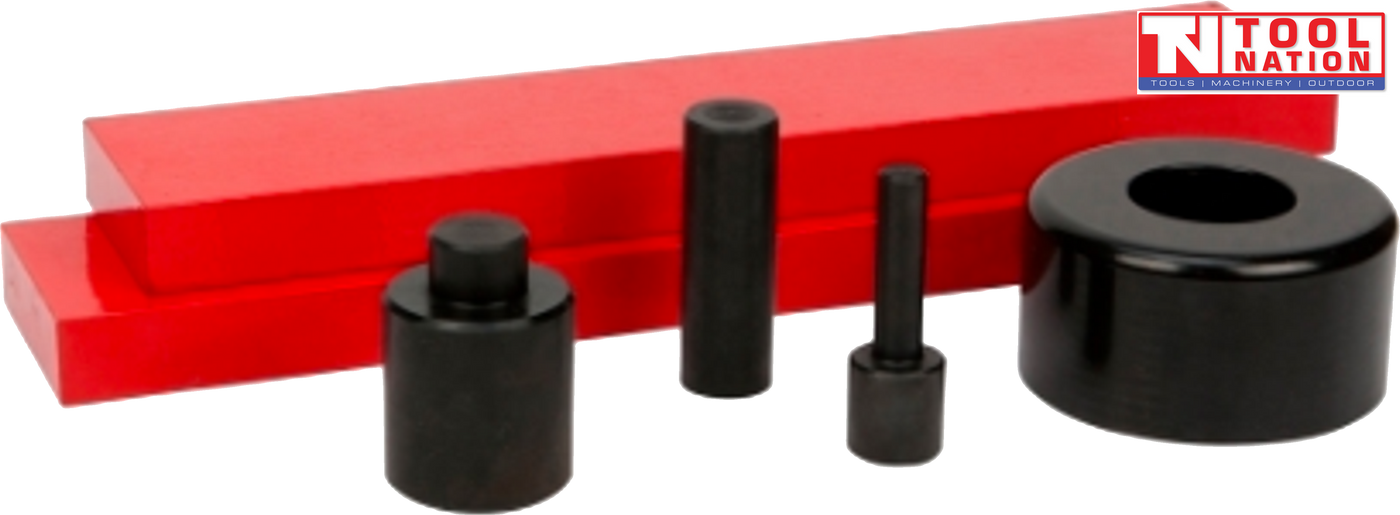 Angled view of press accessory kit with two red press plates, three black adaptor pins, and black bearing shield on black background