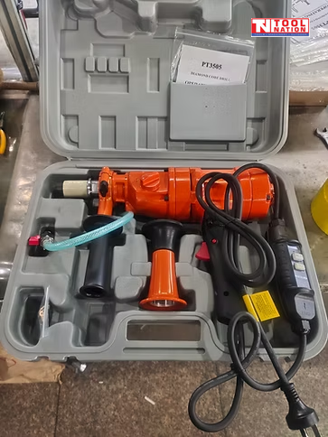 Orange handheld core drill inside an open grey carry case with power cord, side handle, hose, and switch box.