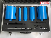Open carry case containing blue core drill bits, metal adapters, drill bits, black foam insert, and logo in the top corner.