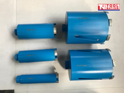 Five blue core drill bits of different sizes with segmented metal cutting teeth and logo in the top corner.