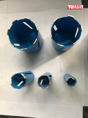 Top view of five blue core drill bits with segmented metal cutting teeth and logo in the top corner.