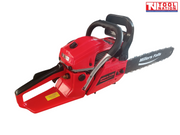 Red chainsaw shown from the rear side with a black guide bar, chain, front handle, rear handle and visible warning label.