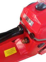 Close-up of a red chainsaw body showing the rear handle area, black cap, small clear primer bulb and warning label.