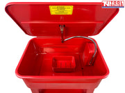 Red parts washer front view with lid open, flexible hose, yellow warning label, and lower shelf