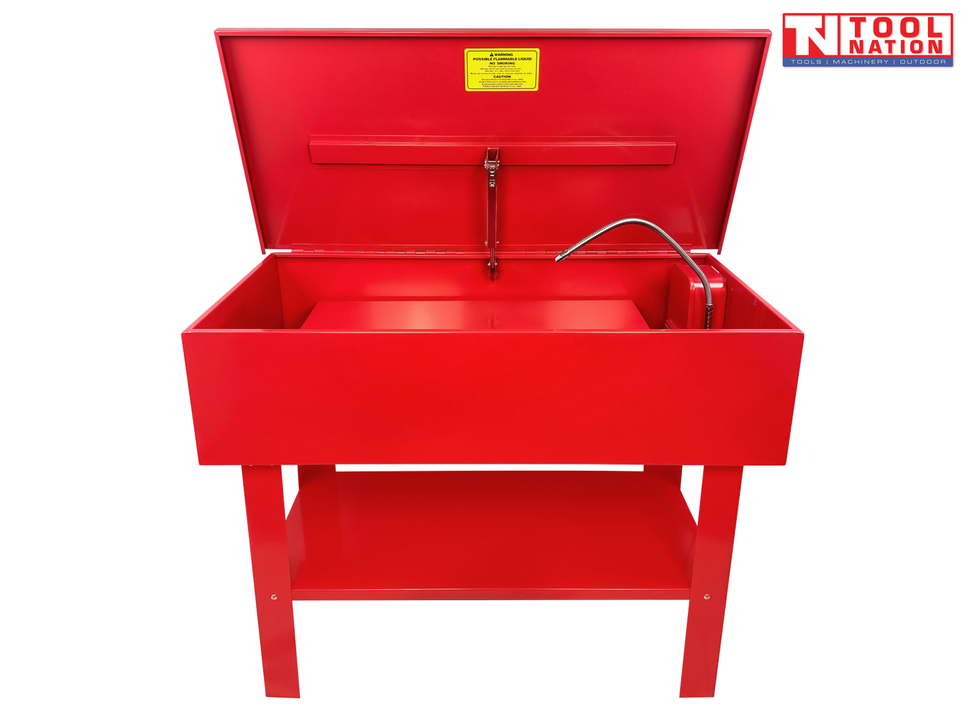 Red parts washer front view with lid open, flexible hose, yellow warning label, and lower shelf