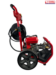 Side view of a red pressure washer with coiled hose reel, engine, large wheel, hose, front guard, and a logo in the top right corner.