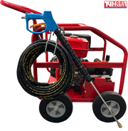 Side view of a red pressure washer with blue spray gun, black coiled hose, four wheels, engine, and a logo in the top right corner.