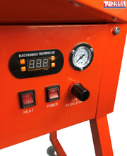 Close-up of control panel with thermostat display, pressure gauge, heat and power switches, and air regulator