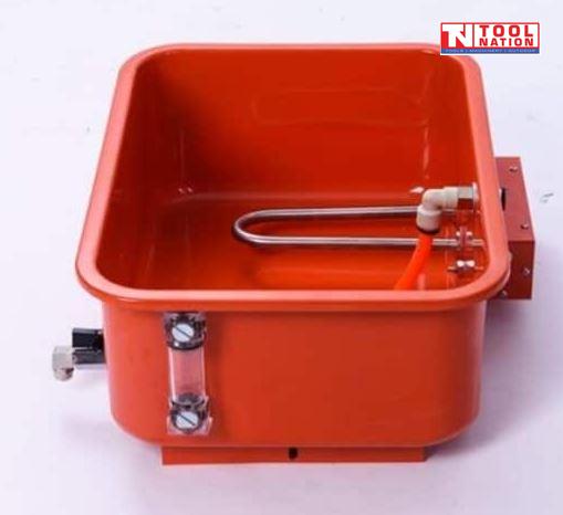 Close-up of removable tank with heating element, orange hose, and clear level gauge