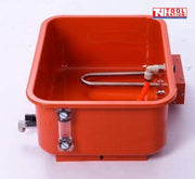 Close-up of removable tank with heating element, orange hose, and clear level gauge