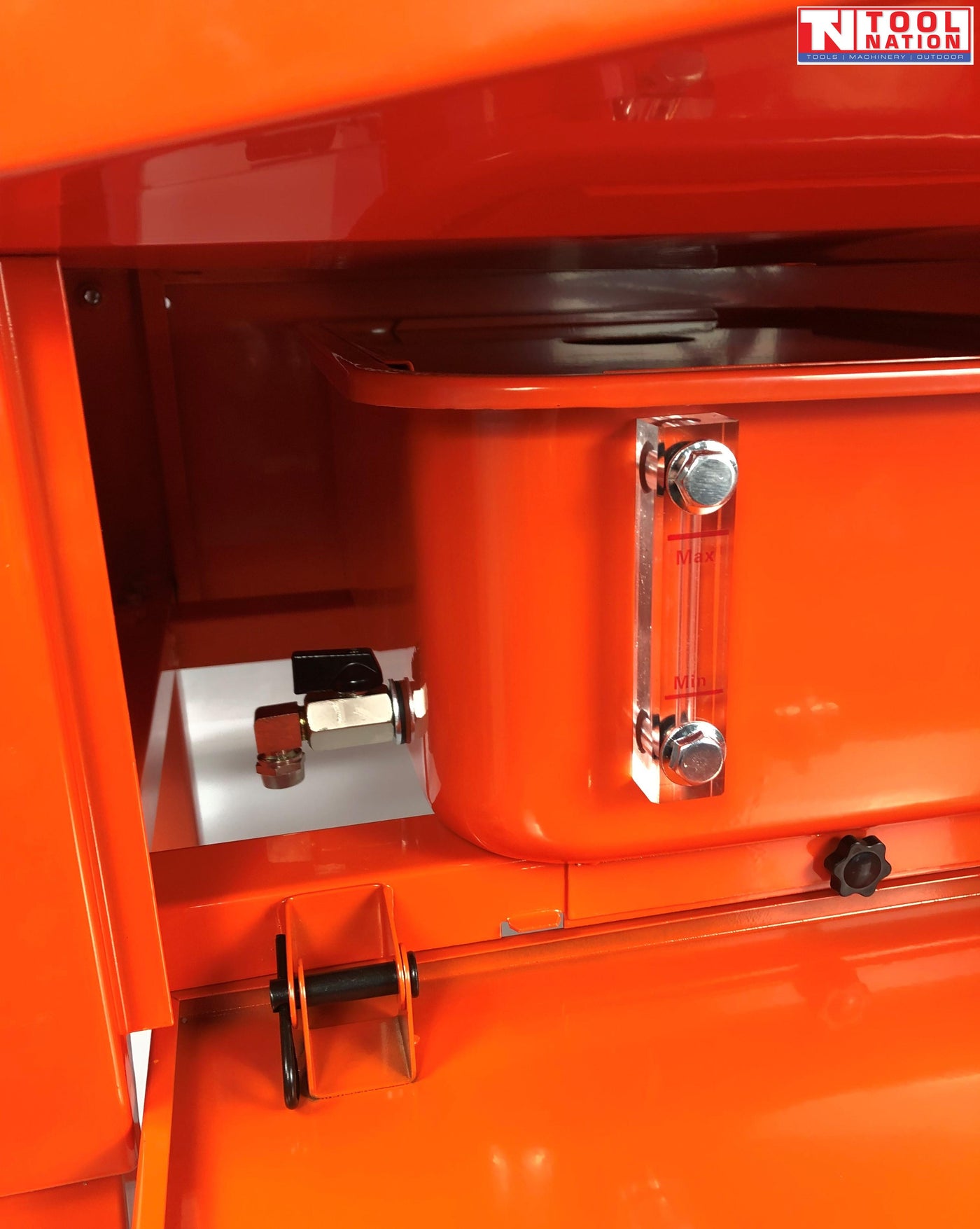 Close-up of lower side compartment with tank, drain valve, and clear level gauge marked max and min
