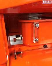 Close-up of lower side compartment with tank, drain valve, and clear level gauge marked max and min