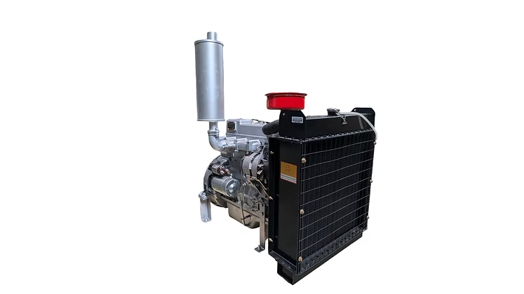 Silver diesel engine shown from the radiator side with a black radiator, vertical silver exhaust, red air filter and hoses visible.