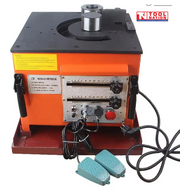 Orange bench-mounted rebar bender with top bending rollers, front controls, blue foot pedals, power cord, labels, and logo in the top corner.