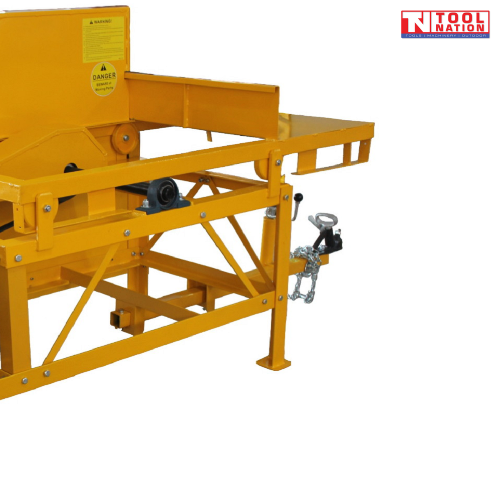 Close-up of a yellow towable saw bench showing the cutting table, frame, tow hitch, chain, warning labels and Tool Nation logo.