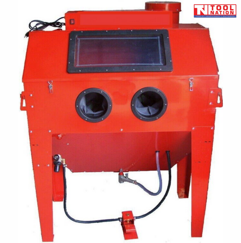 Front view of a red sandblasting cabinet with a large top viewing window, two circular glove ports, hoses below and a foot pedal on the floor.
