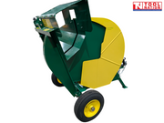 Rear side view of a green and yellow towable saw bench showing the blade guard, cutting cradle, two wheels and Tool Nation logo.