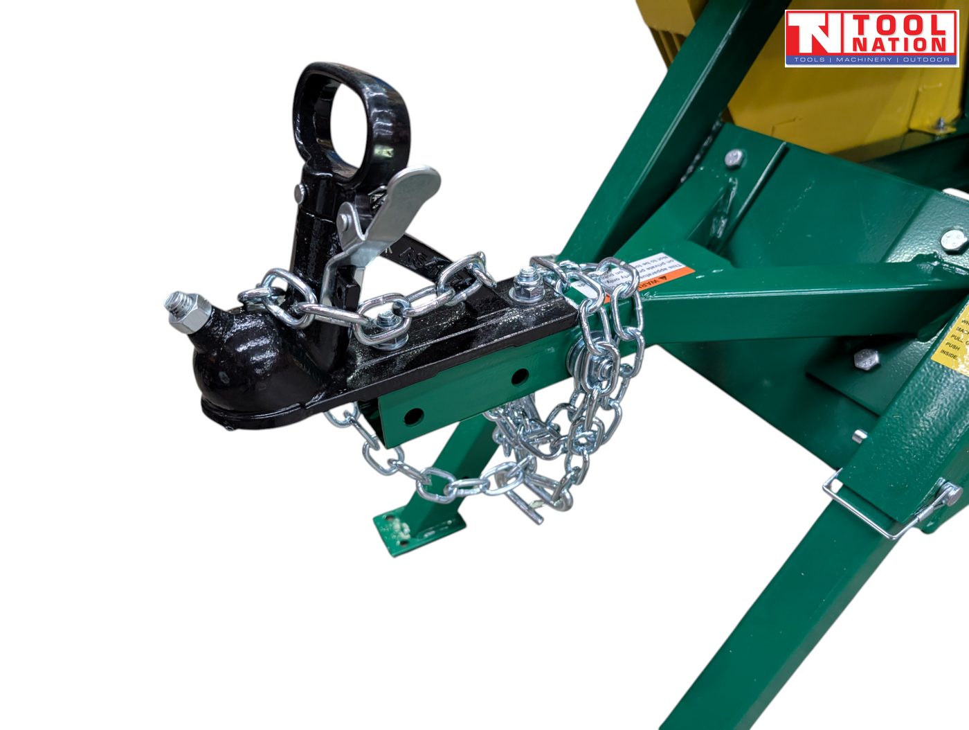 Close-up of a tow hitch assembly showing a black coupler, metal latch, safety chains, green drawbar and bolts.