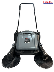 Front view of a grey and black manual sweeper with two round side brushes, rear wheels, upright handle and Tool Nation logo.