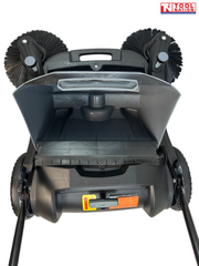 Rear view of a grey and black manual sweeper with the collection bin open, showing two round side brushes, rear wheels and handle rods.