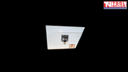 Front view of white steel side tool box with latch on black background