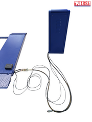 Partial side view of a blue control unit connected by hoses and cables to the corner of a blue lift platform on a light grey background.