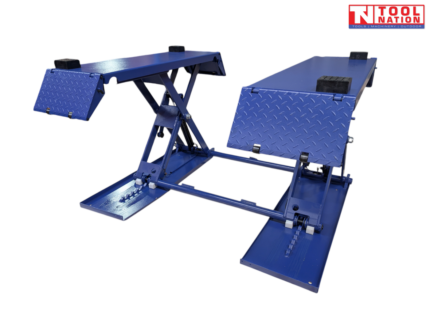 Angled front view of a blue mid-rise car lift with both platforms raised, diamond-plate end ramps folded down, black rubber blocks, and a light grey background.