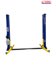 Front view of a blue two-post vehicle lift with yellow lifting arms and a blue floor plate between the posts on a light grey background.