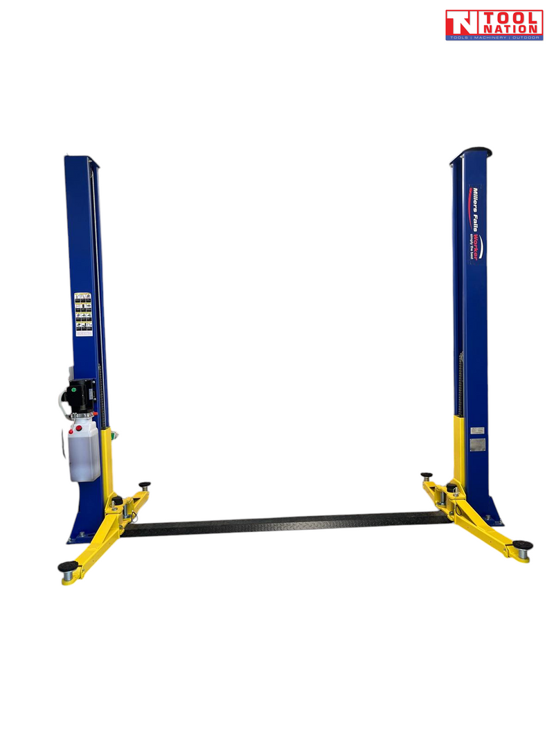 Front view of a blue two-post vehicle lift with yellow lifting arms and a blue floor plate between the posts on a light grey background.