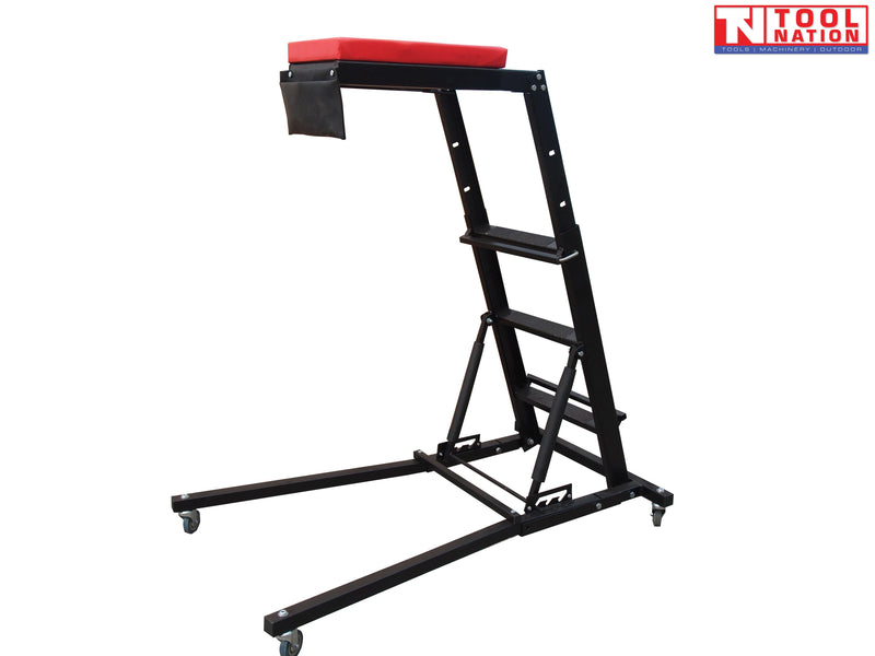 Topside creeper angled view with red padded platform, ladder steps, side tray, support struts, and casters