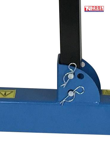 Close-up of blue frame bracket with two retaining pins on tractor wheel dolly